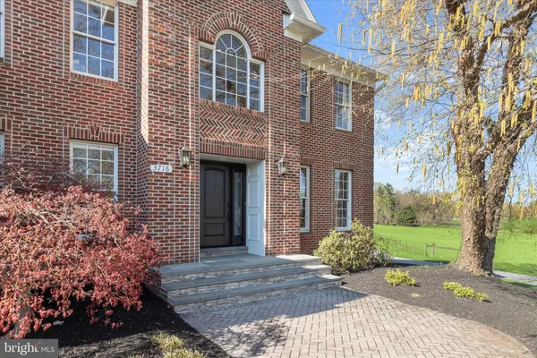 a view of an entryway with wooden floor and windows