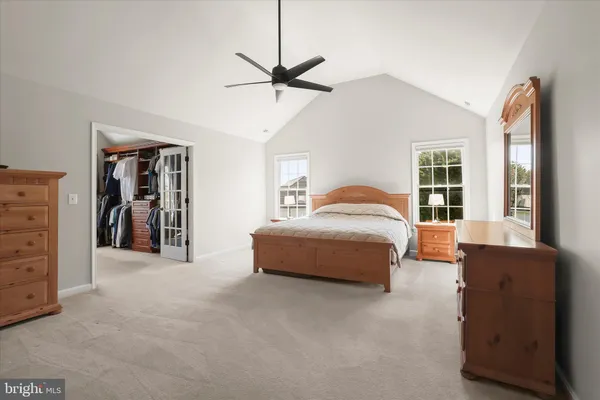 a large tree in front of a brick house with a large tree