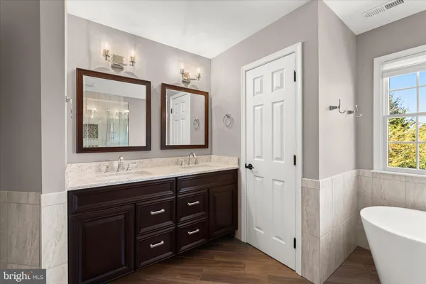 a view of a patio with table and chairs potted plants and large tree
