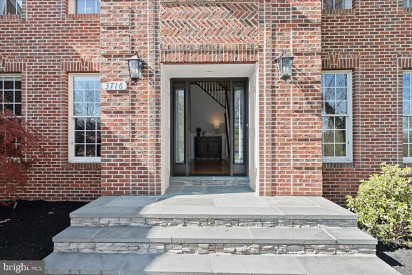 a view of an entryway with wooden floor and door