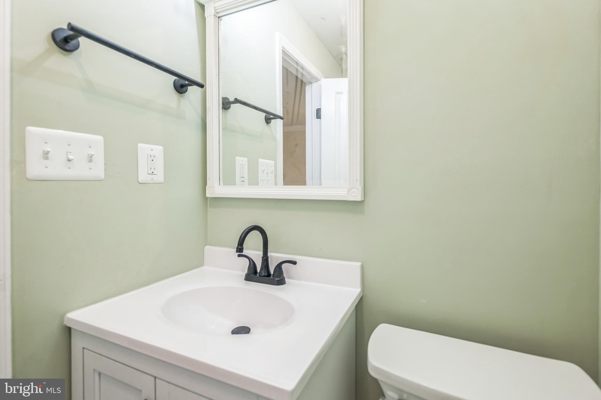 413 Bowleys Quarters Road Middle River, MD 21220 - Photo 27 of 38 a bathroom with a sink a toilet and mirror