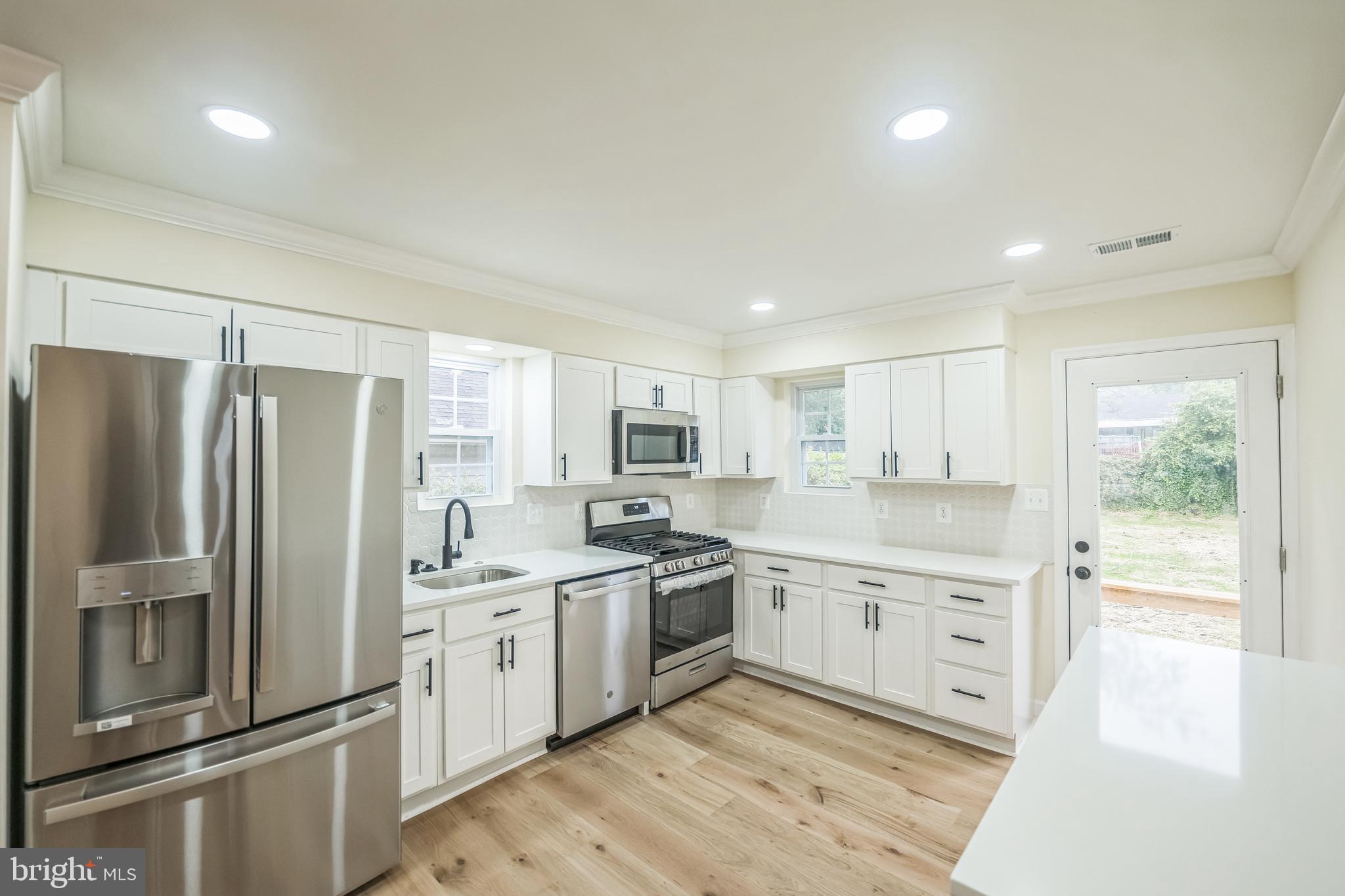 413 Bowleys Quarters Road Middle River, MD 21220 - Photo 10 of 38 a kitchen with a refrigerator sink and cabinets