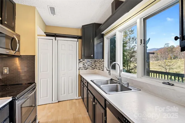 a kitchen with a sink and a large window