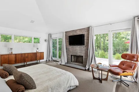 a bedroom with a bed and a fireplace
