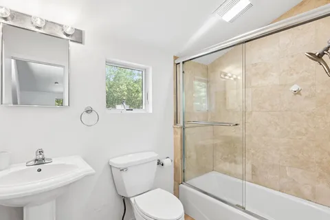 a bathroom with a toilet a sink and a shower