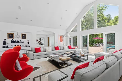 a living room with furniture and large windows