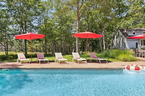 an outdoor space with patio the table and chairs under an umbrella