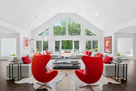 a dining room with furniture window and wooden floor