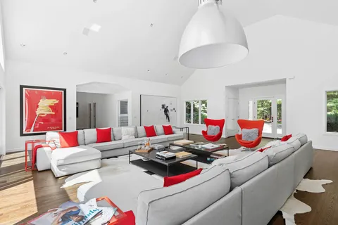 a living room with furniture and a air conditioner vent