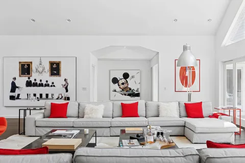 a living room with couch flowerpot and window