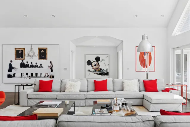 a living room with couch flowerpot and window