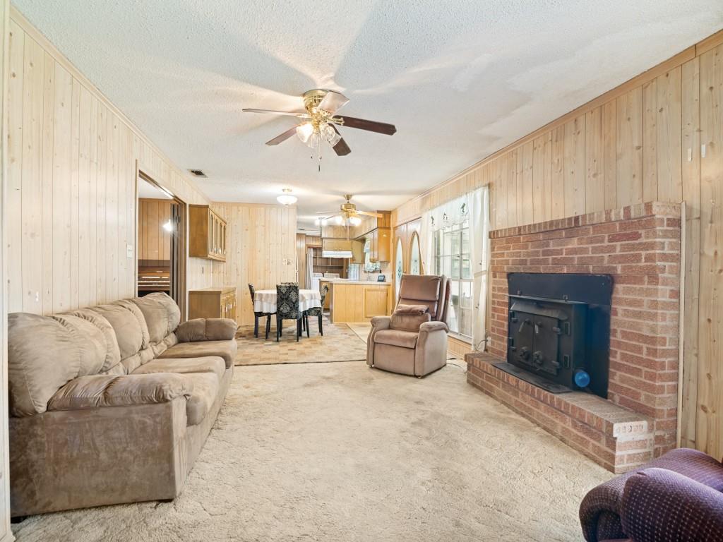 1081 Wright Street Terrell, TX 75160 - Photo 10 of 29 Living area featuring a brick fireplace with an insert