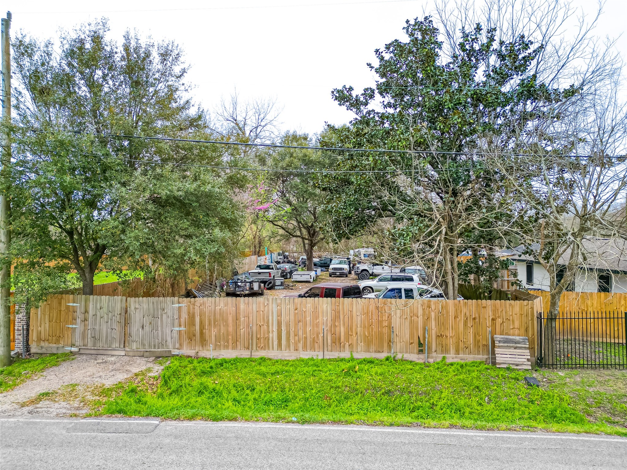 5206 Denmark Street Houston, TX 77016 - Photo 2 of 17 a view of a backyard with wooden fence and trees