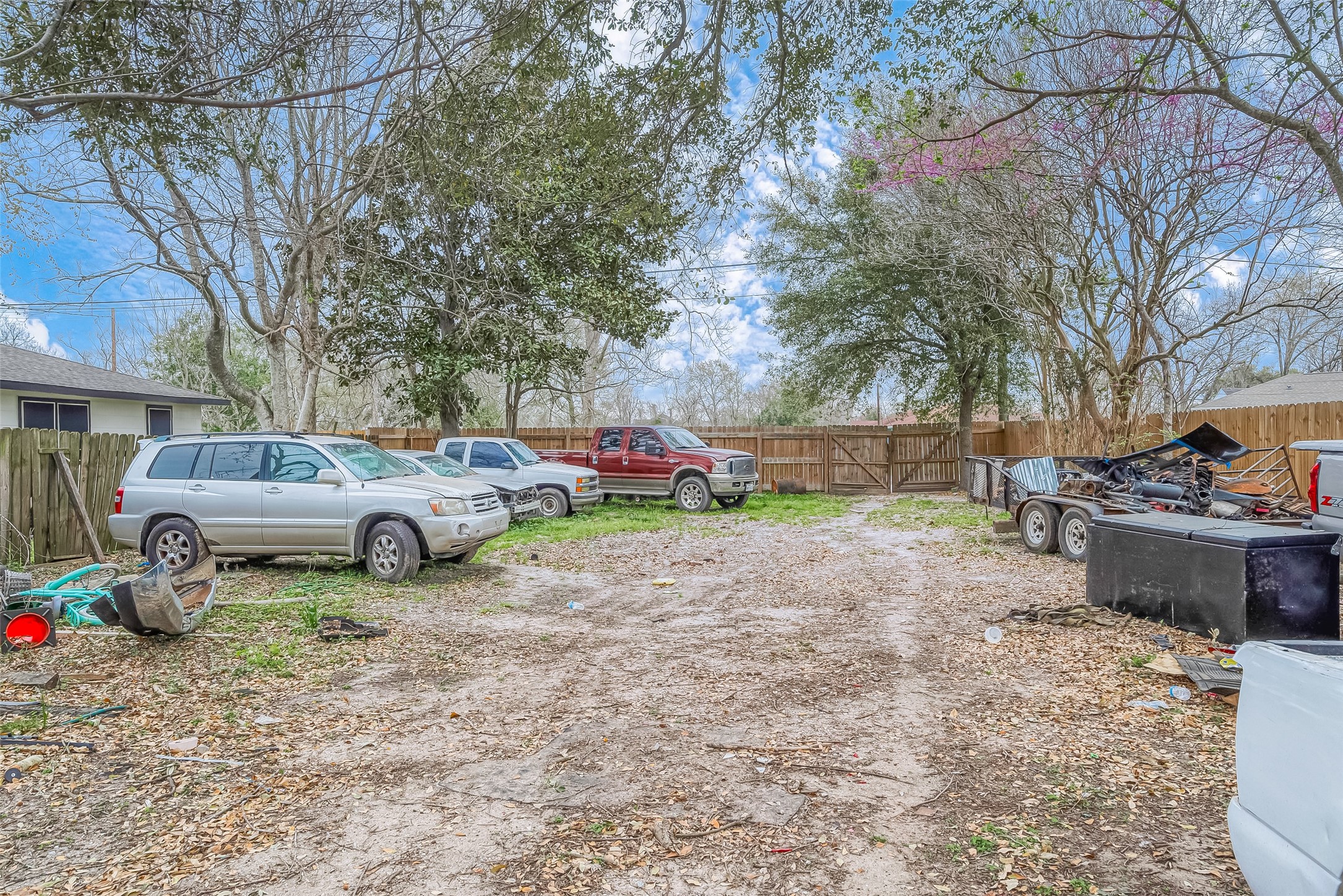 5206 Denmark Street Houston, TX 77016 - Photo 3 of 17 a view of a backyard with a car parked