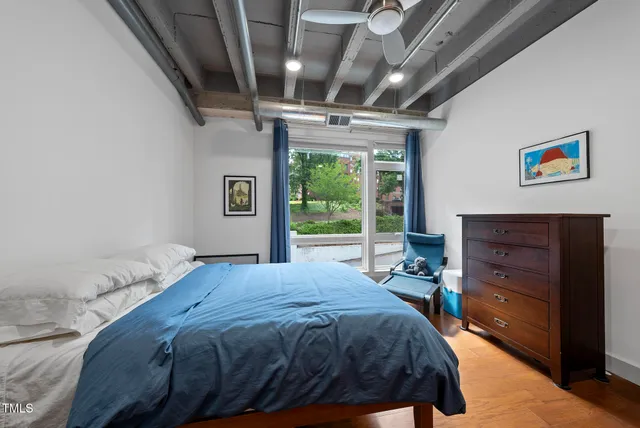 a bed sitting in a bedroom next to a window