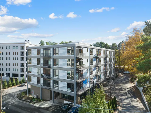 a view of a large building with a yard