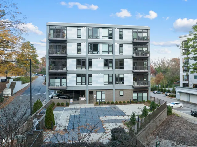 a front view of a building with glass windows and a table