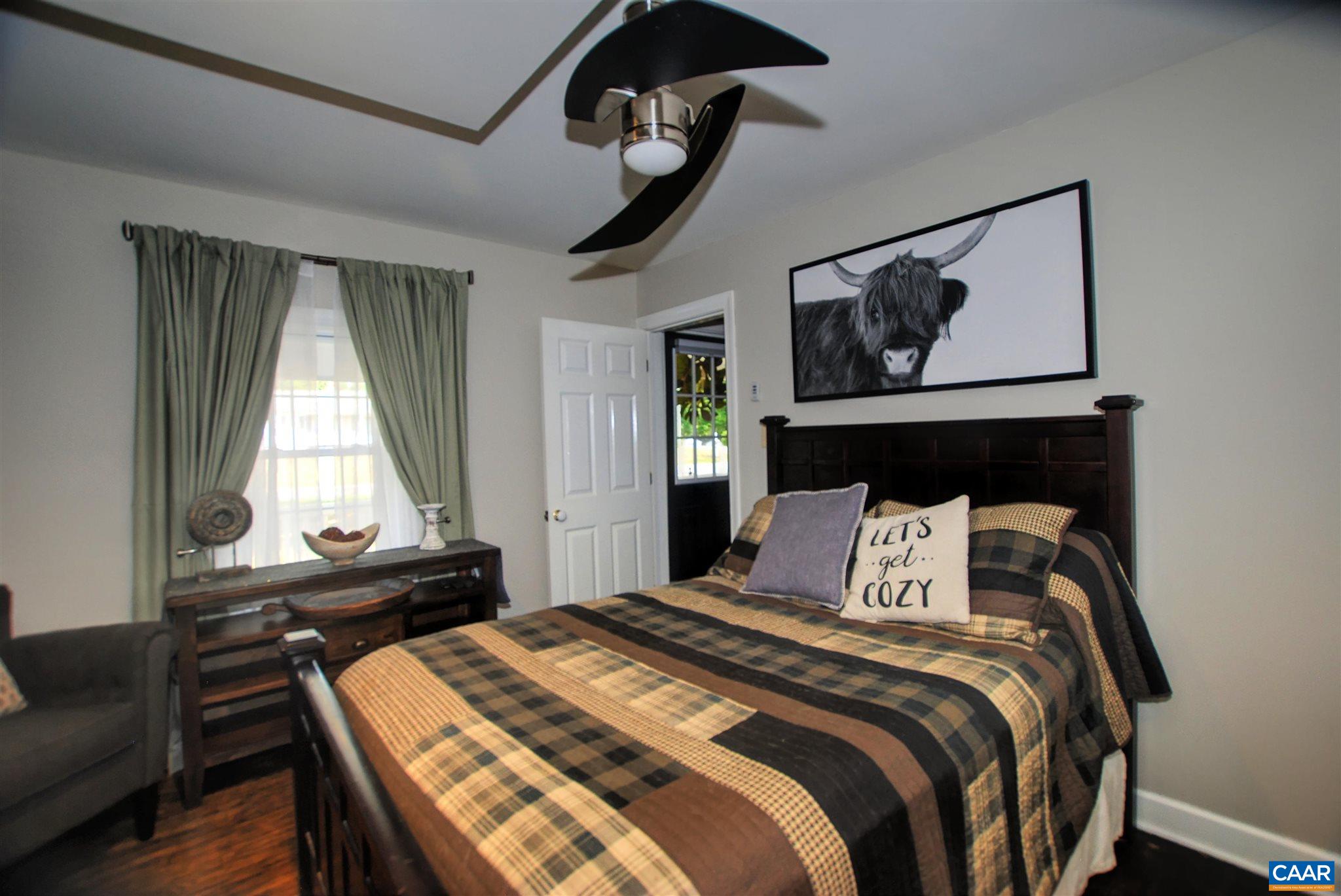 358 Fredericksburg Road Ruckersville, VA 22968 - Photo 11 of 23 a bedroom with a bed and wooden floor