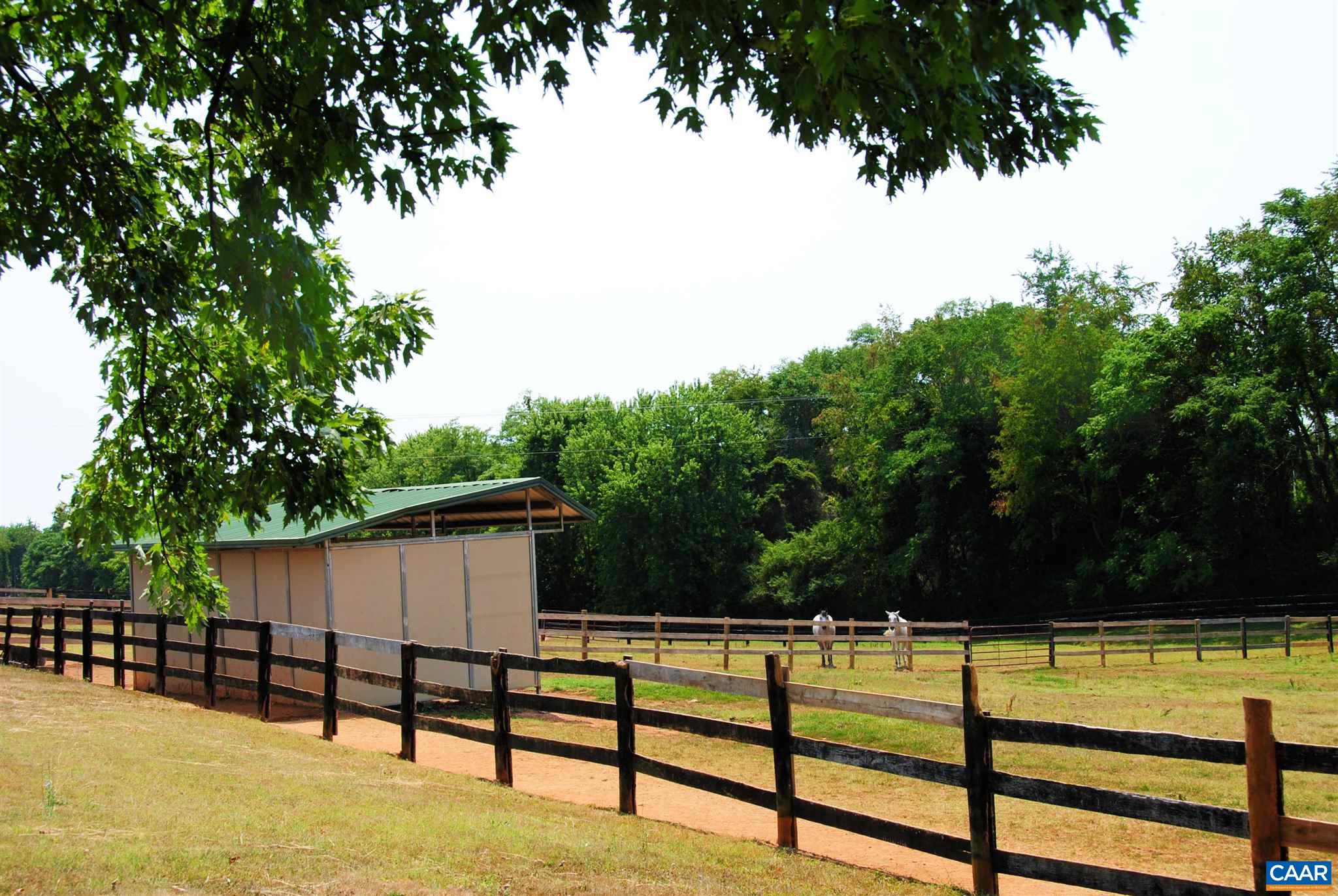 358 Fredericksburg Road Ruckersville, VA 22968 - Photo 18 of 23 a view of a swimming pool with a bench and trees in the background