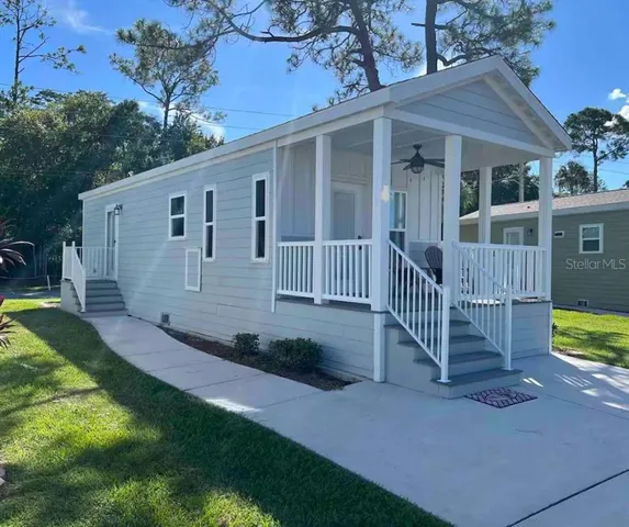 a view of a house with a yard and deck
