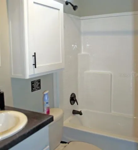 a bathroom with a tub and a sink