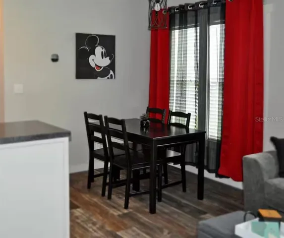 a view of a dining room with furniture and window