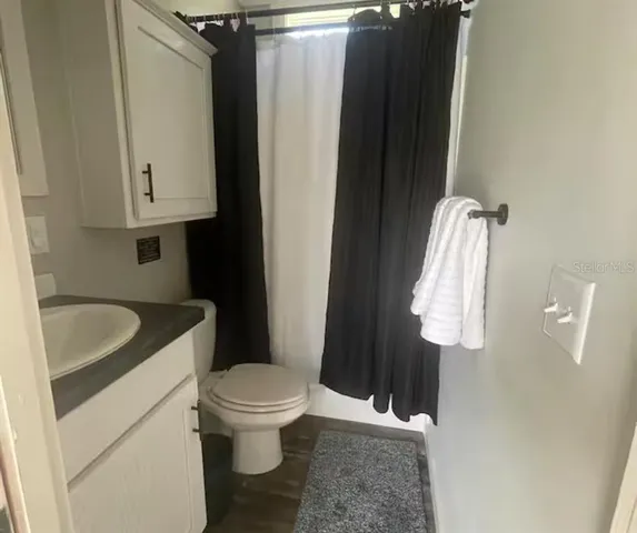 a bathroom with a sink toilet and vanity