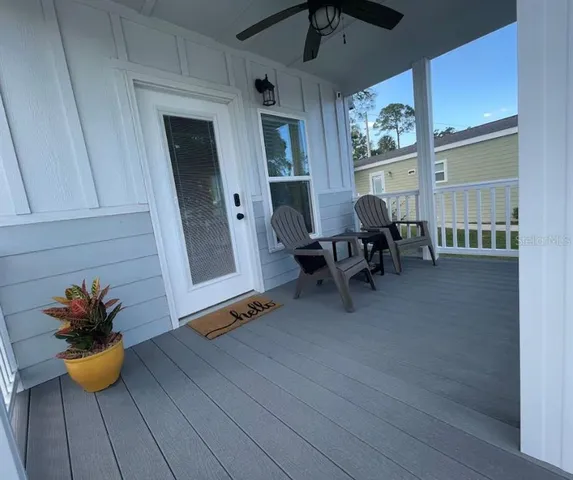 a view of a dining room with furniture and a potted plant