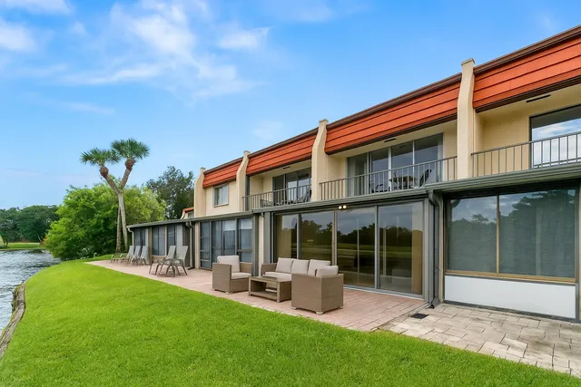 a backyard of a house with table and chairs