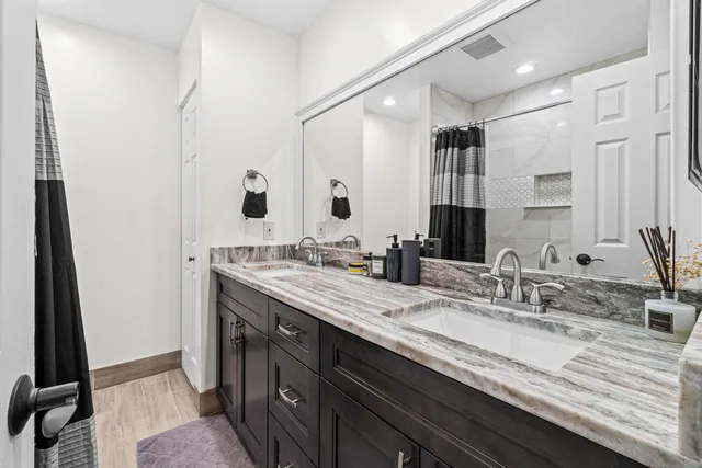 a bathroom with a double vanity sink and a mirror