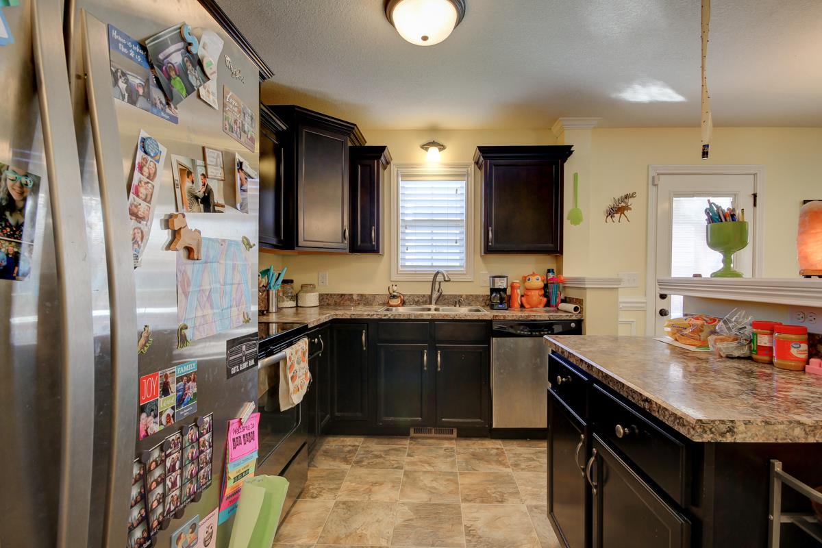 3725 Suiter Road Clarksville, TN 37040 - Photo 5 of 15 a kitchen with stainless steel appliances granite countertop a sink stove and refrigerator