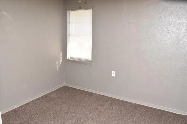 a living room with furniture a window and a view of dining room
