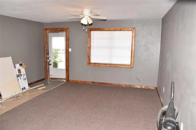 an empty room with windows and closet
