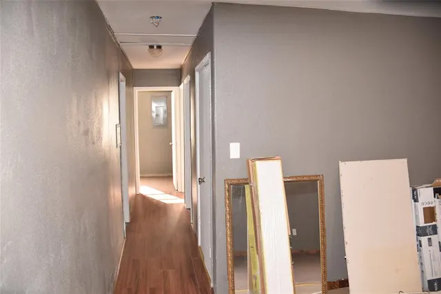 a white bath tub sitting next to a white toilet and vanity