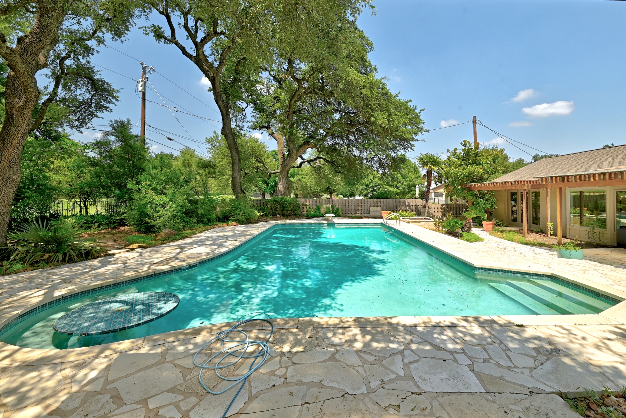 8608 Crest Ridge Circle Austin, TX 78750 - Photo 33 of 38 A spacious backyard oasis with a refreshing in-ground pool and ample patio for lounging.