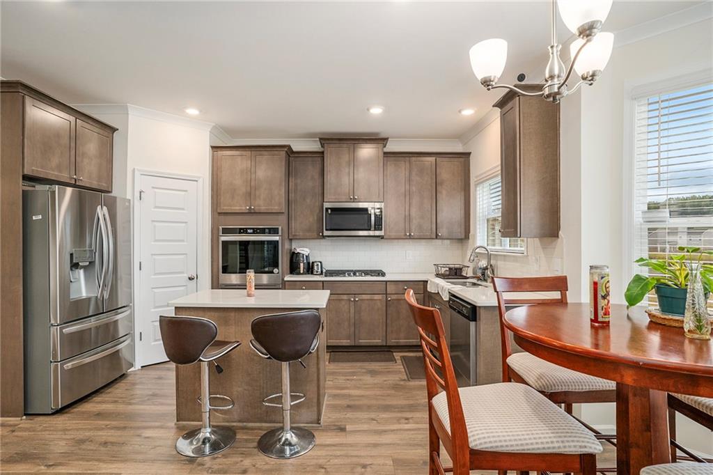 13709 Whitman Lane Covington, GA 30014 - Photo 12 of 36 a kitchen with granite countertop a center island stainless steel appliances cabinets and a counter top space