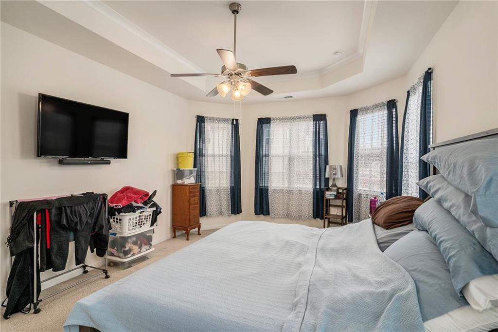 13709 Whitman Lane Covington, GA 30014 - Photo 16 of 36 a bedroom with a bed and a flat screen tv