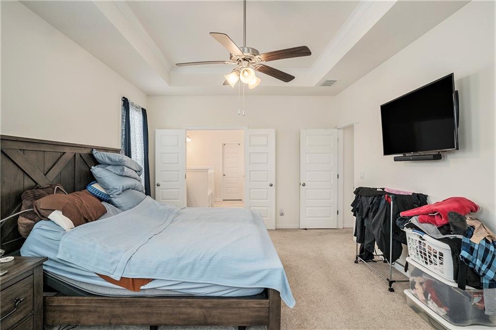 13709 Whitman Lane Covington, GA 30014 - Photo 17 of 36 a bedroom with a bed and a flat screen tv