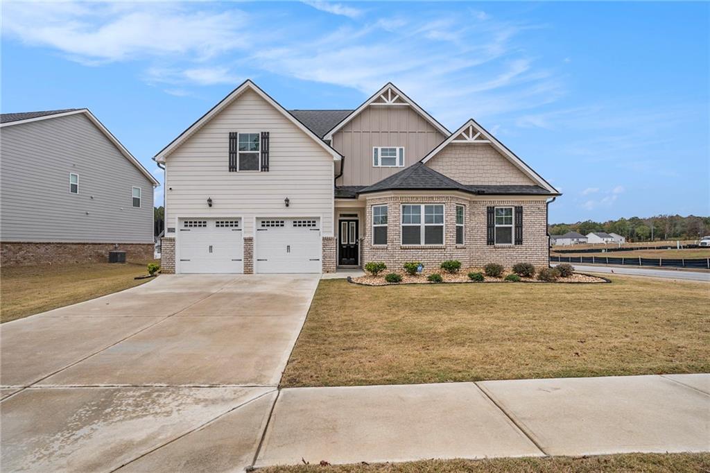 13709 Whitman Lane Covington, GA 30014 - Photo 2 of 36 a front view of a house with a yard and garage