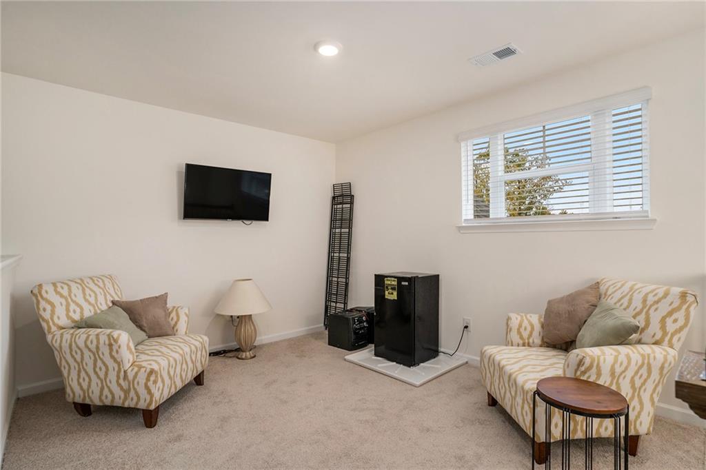13709 Whitman Lane Covington, GA 30014 - Photo 23 of 36 a living room with furniture and a flat screen tv