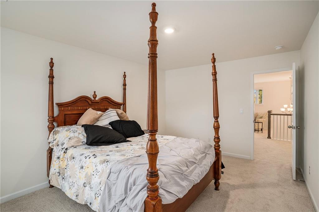 13709 Whitman Lane Covington, GA 30014 - Photo 26 of 36 a bedroom with a bed and a chandelier