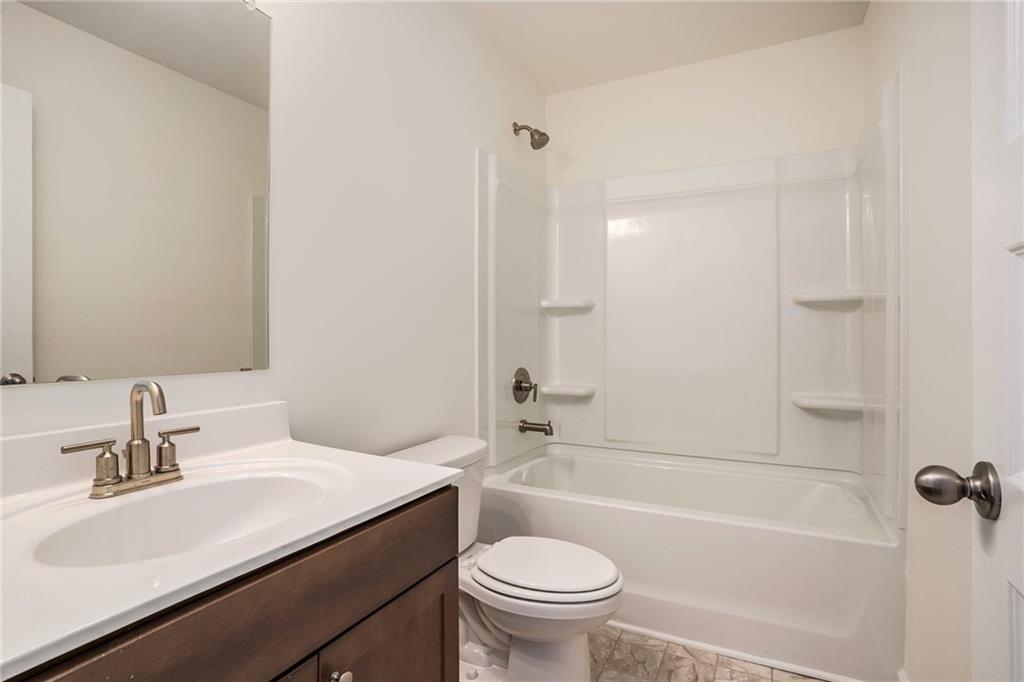 13709 Whitman Lane Covington, GA 30014 - Photo 27 of 36 a bathroom with a sink a toilet and a mirror