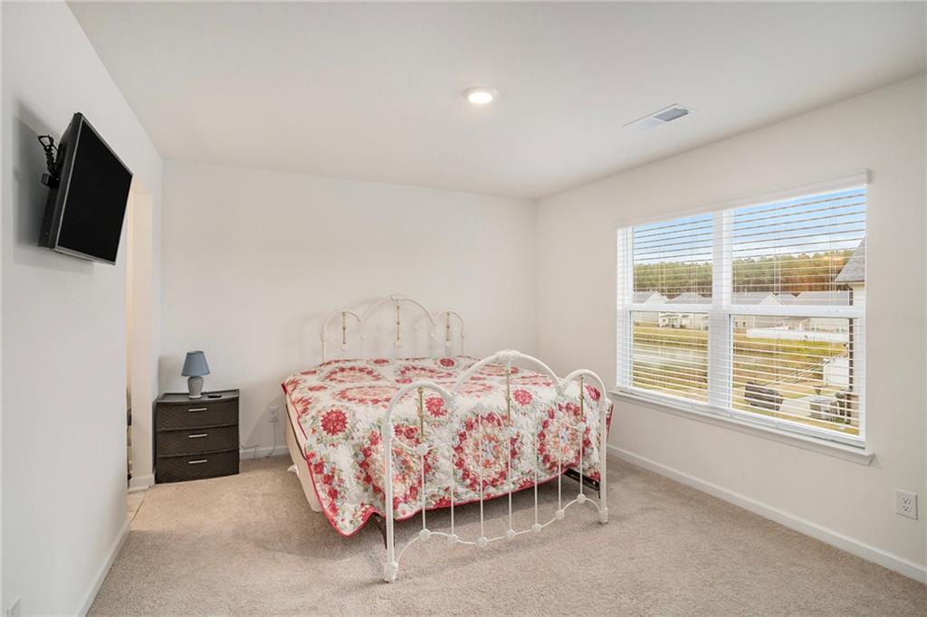 13709 Whitman Lane Covington, GA 30014 - Photo 28 of 36 a bedroom with a bed and a flat screen tv