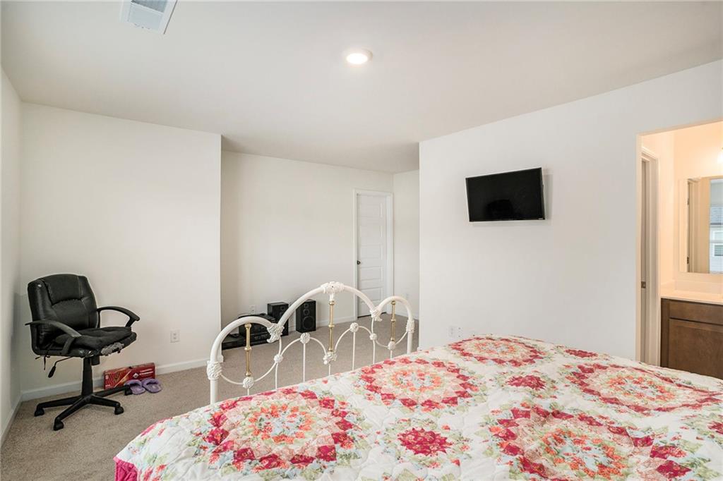 13709 Whitman Lane Covington, GA 30014 - Photo 29 of 36 a bedroom with a bed a desk and chair