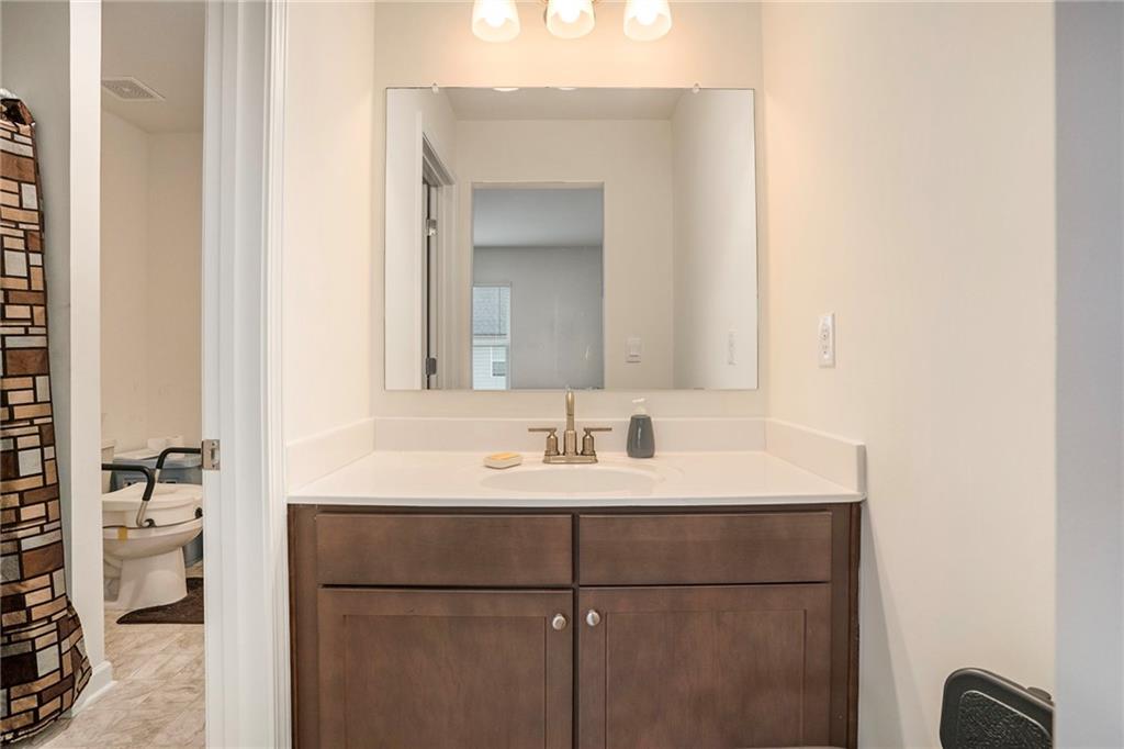 13709 Whitman Lane Covington, GA 30014 - Photo 30 of 36 a bathroom with a sink and a mirror