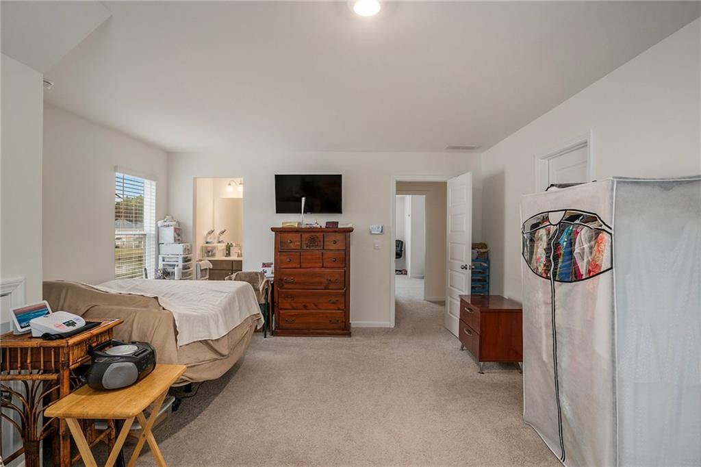 13709 Whitman Lane Covington, GA 30014 - Photo 31 of 36 a bedroom with furniture and a bed