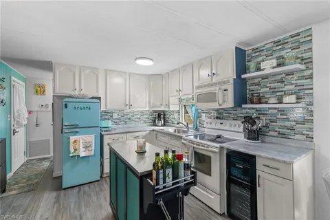 a kitchen with stainless steel appliances granite countertop a stove refrigerator sink and cabinets