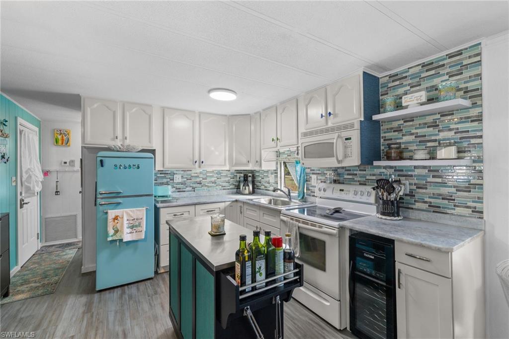 43 Enchanting Boulevard, Unit E43 Naples, FL 34112 - Photo 1 of 36 a kitchen with stainless steel appliances granite countertop a stove refrigerator sink and cabinets