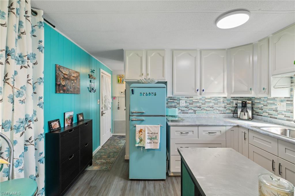 43 Enchanting Boulevard, Unit E43 Naples, FL 34112 - Photo 11 of 36 a kitchen with stainless steel appliances granite countertop a granite counter tops and a refrigerator