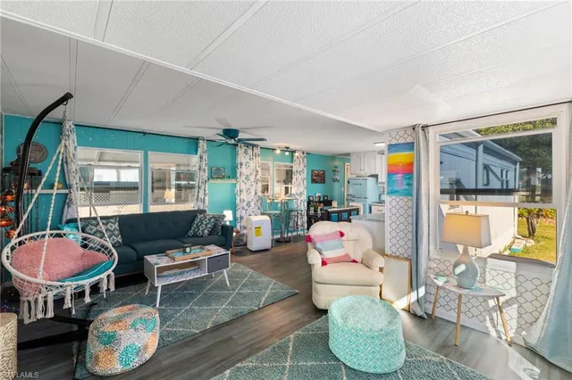 a living room with furniture and a floor to ceiling window
